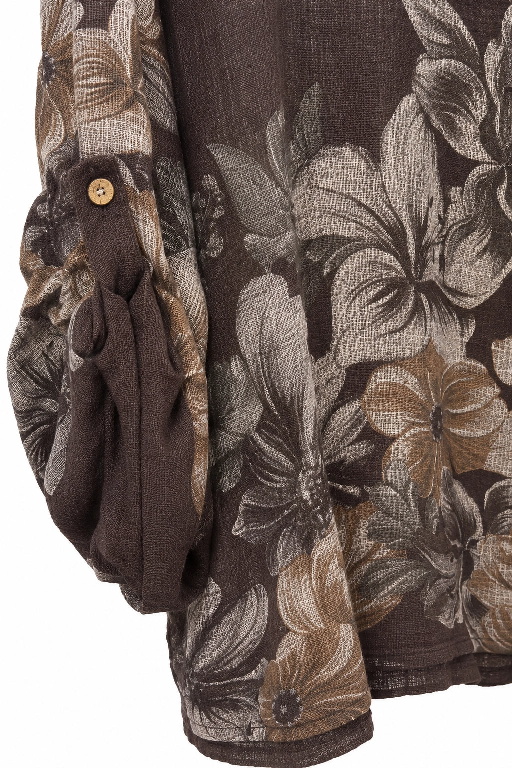 Close-up of a dark brown floral-patterned garment with a large-scale abstract floral print in brown, beige, and gray tones, featuring a gathered sleeve detail with a small gold button.