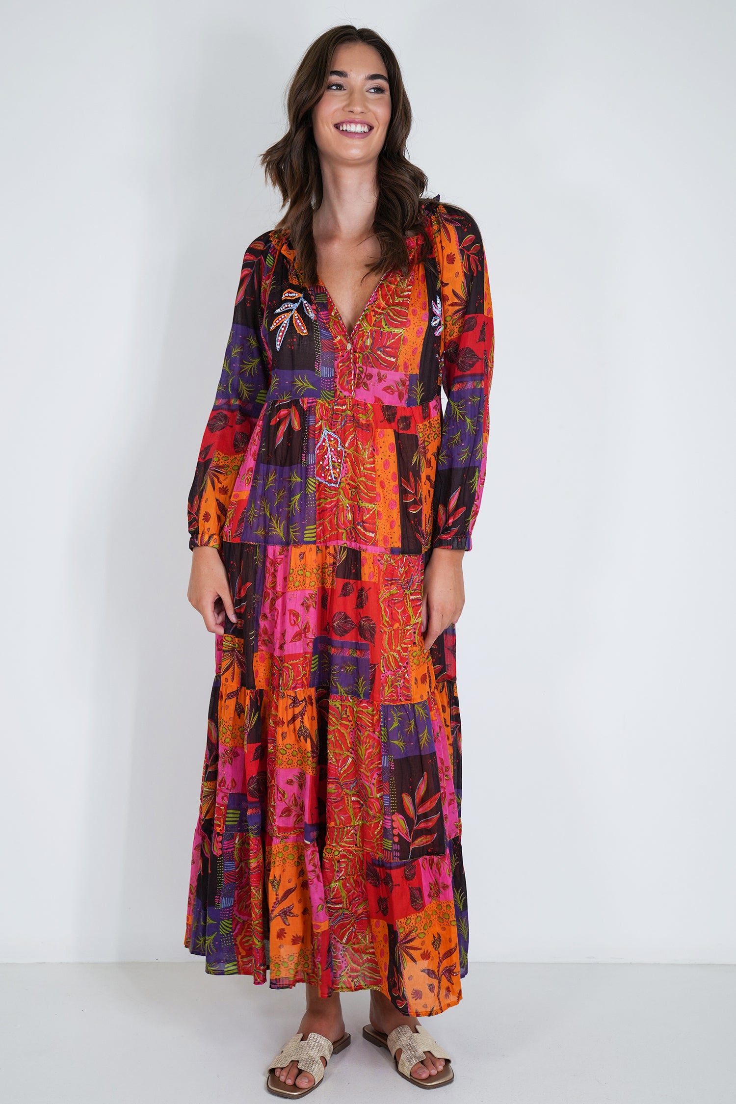 Woman wearing a colorful patterned dress on a white background