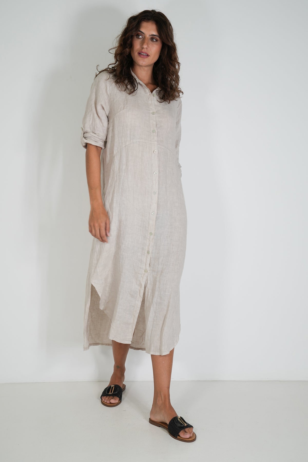 Woman wearing a beige dress against a white background