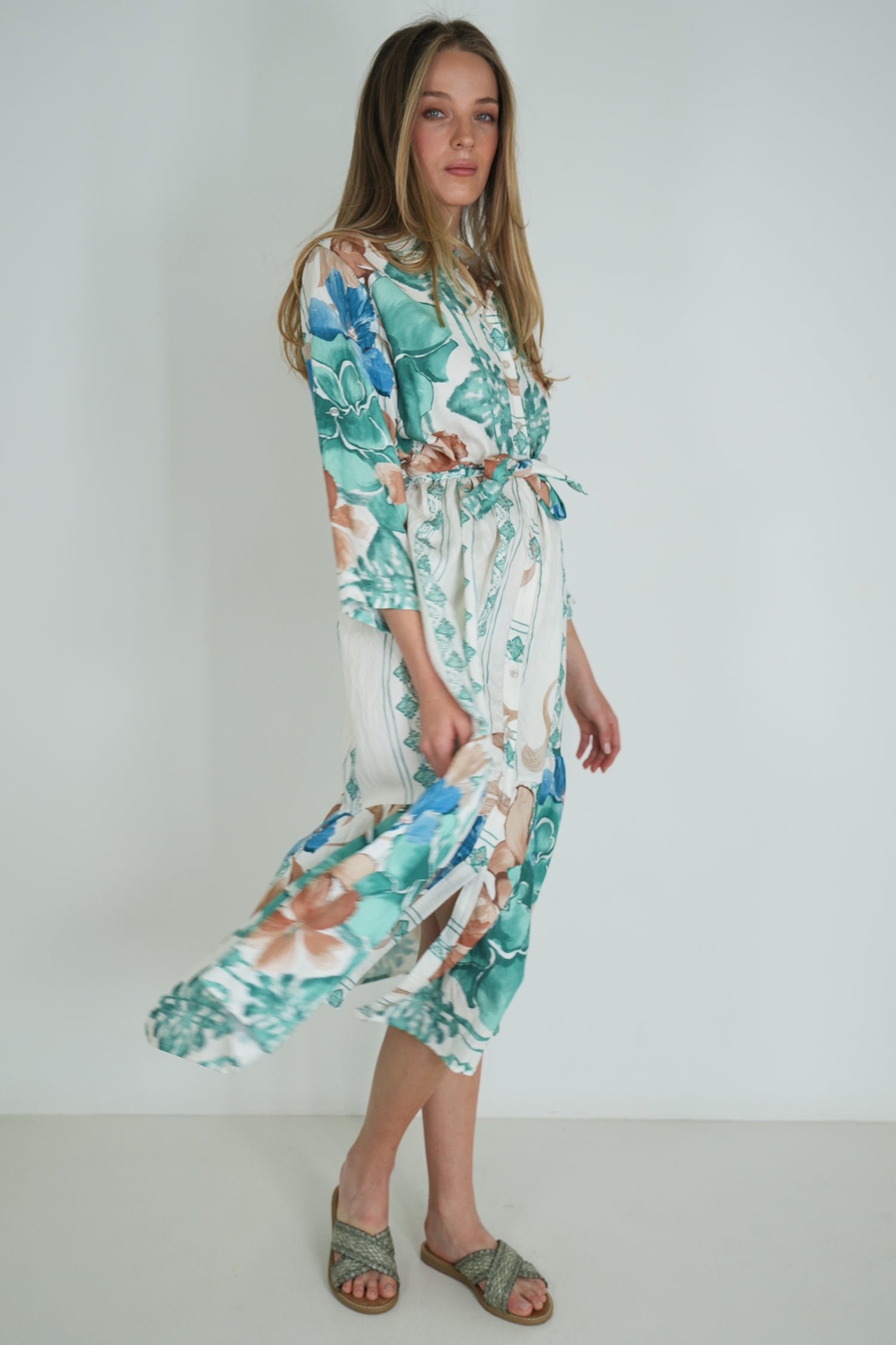 Woman wearing a floral dress against a white background