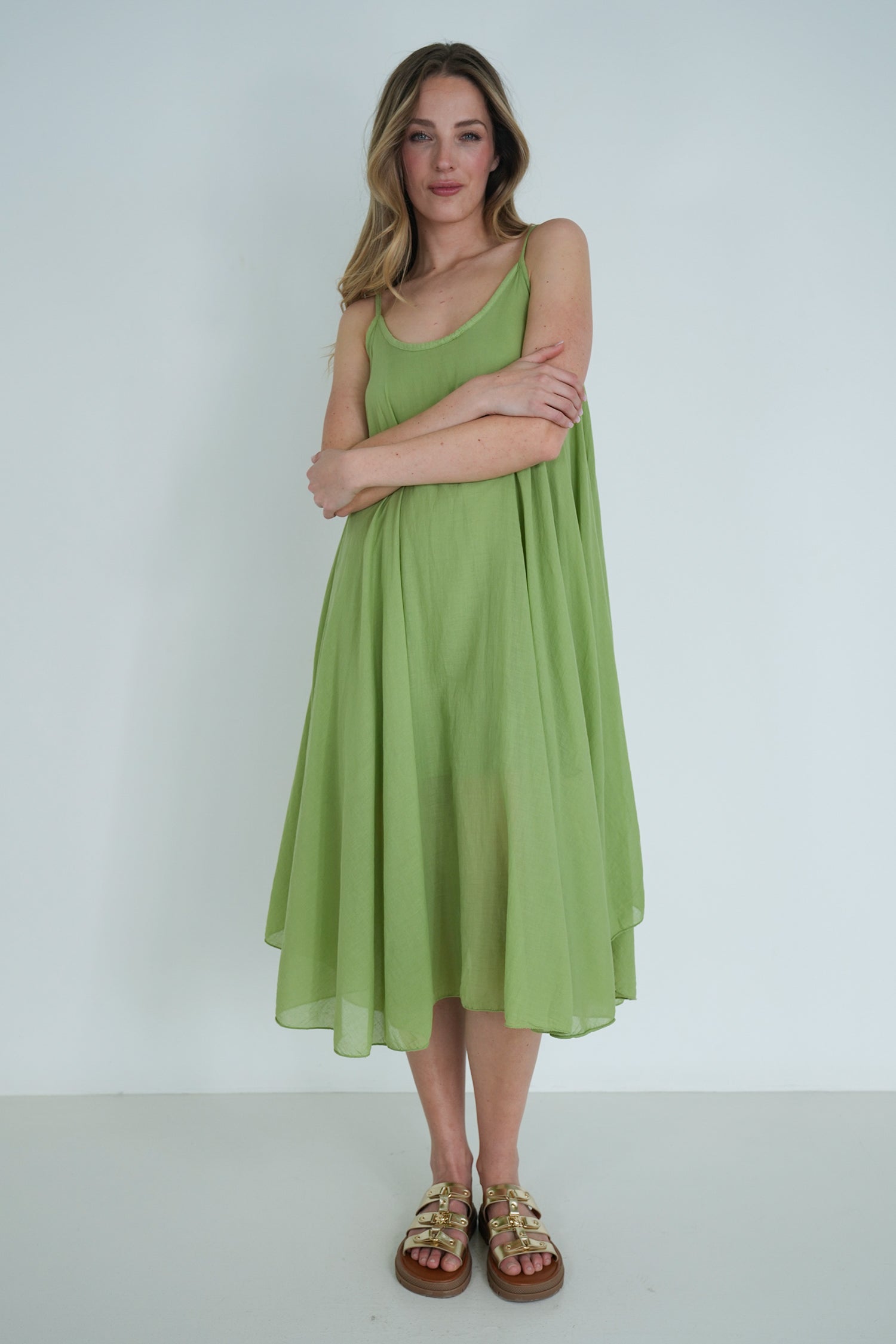 Woman wearing a green dress against a white background