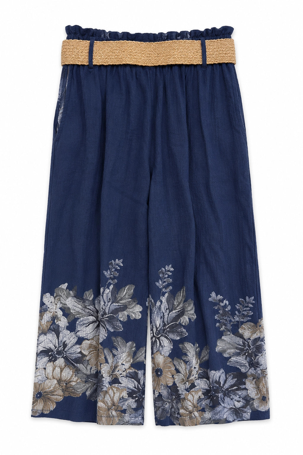 A pair of wide-leg cropped pants in navy blue, featuring a beige woven waistband and a large floral print in beige, gray, and white near the lower hem.