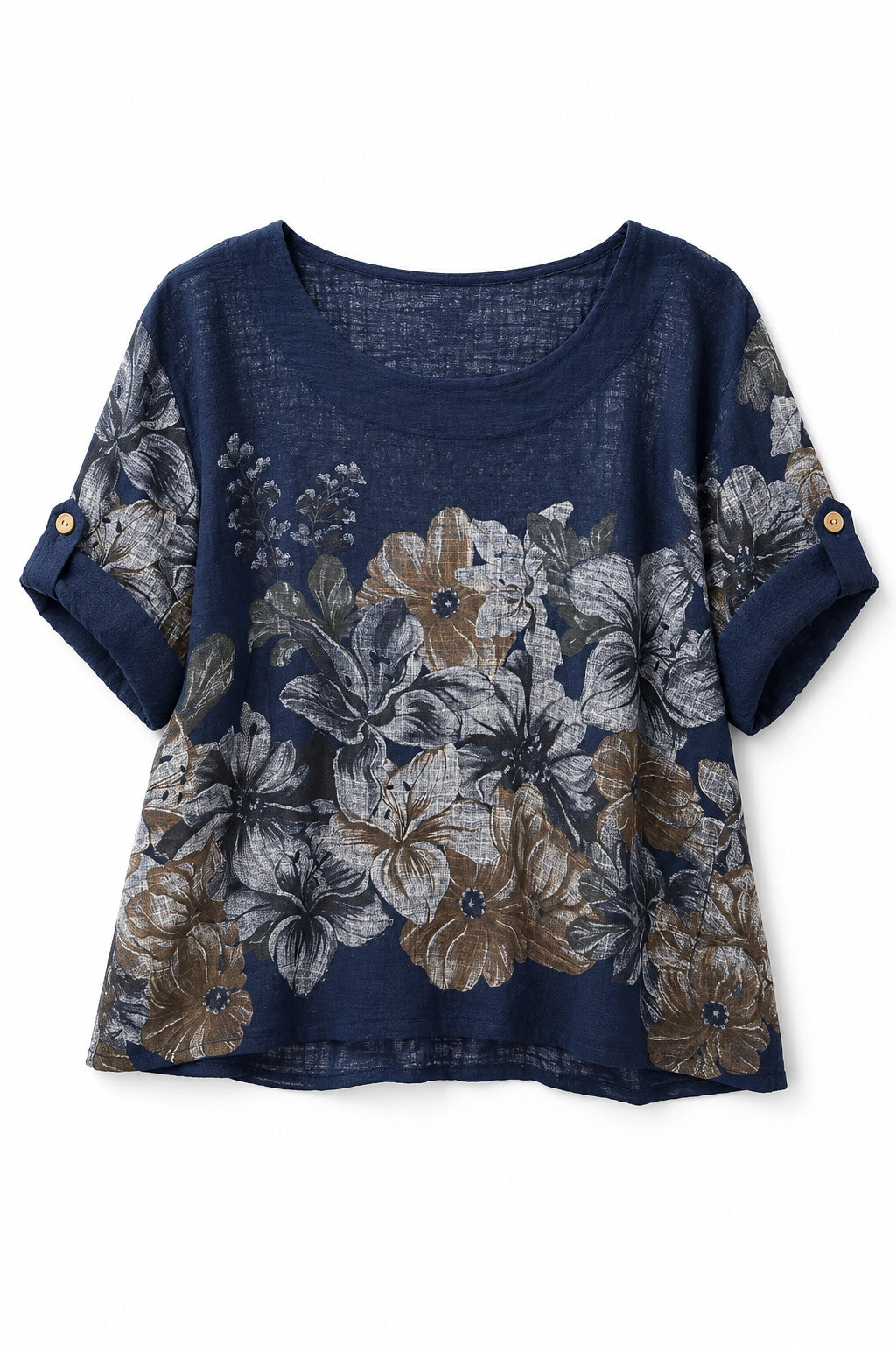 A women's short-sleeve top in navy blue linen-like fabric, featuring a large floral print in beige, gray, and white, with rolled cuffs accented by gold buttons.