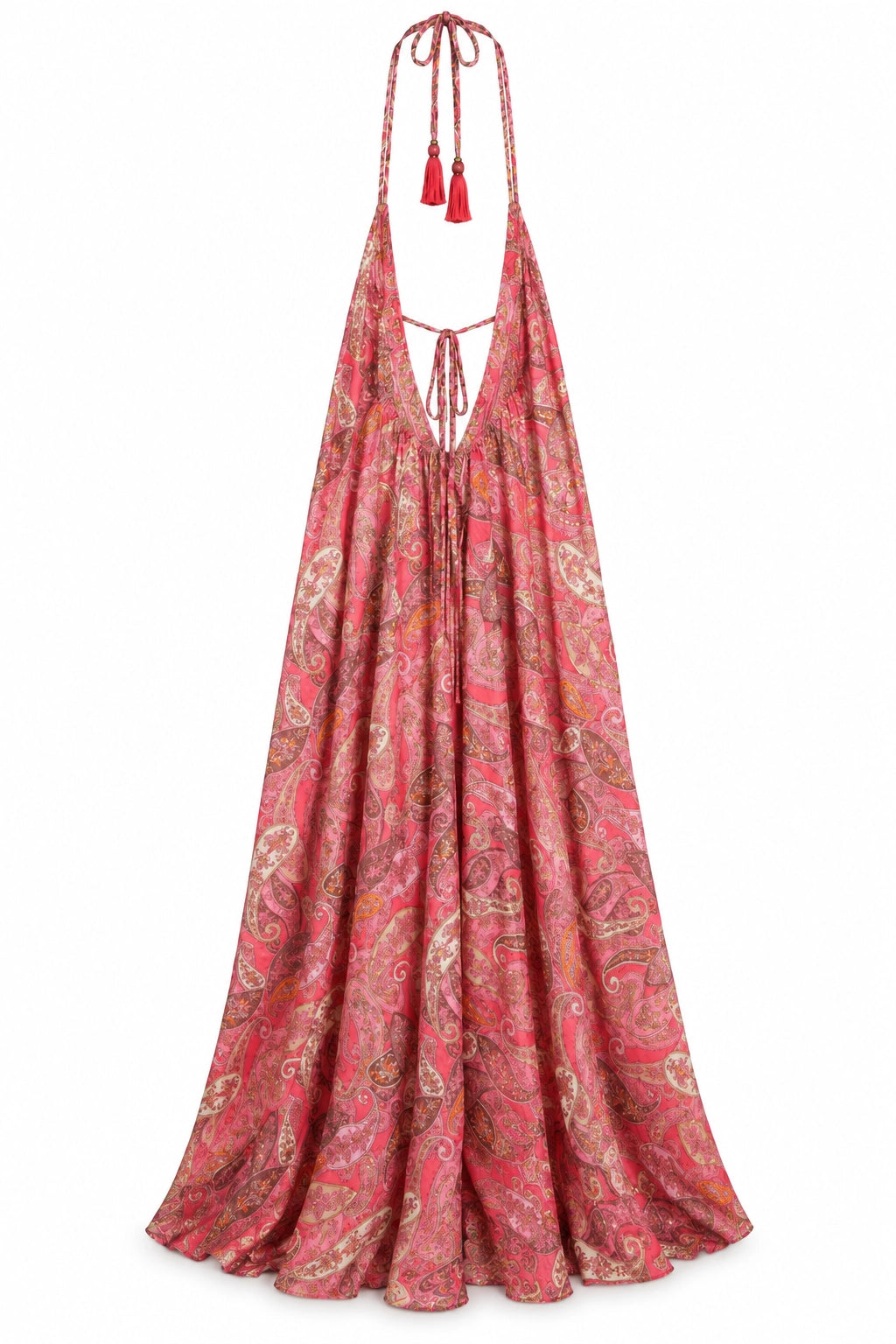 A long halter-neck maxi dress with a red, pink, and gold paisley pattern, featuring red tassels on the shoulder straps, shown against a plain white background.