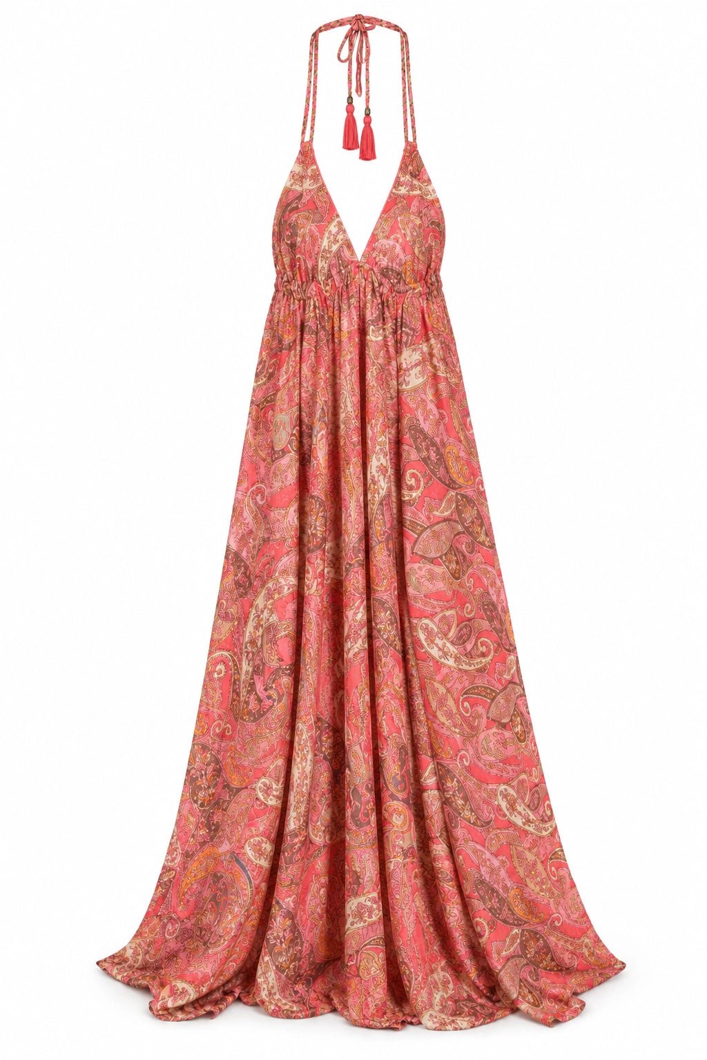 A halter-neck maxi dress with a vibrant paisley pattern in coral pink, red, and gold, featuring tassel ties at the neckline, shown against a plain white background.