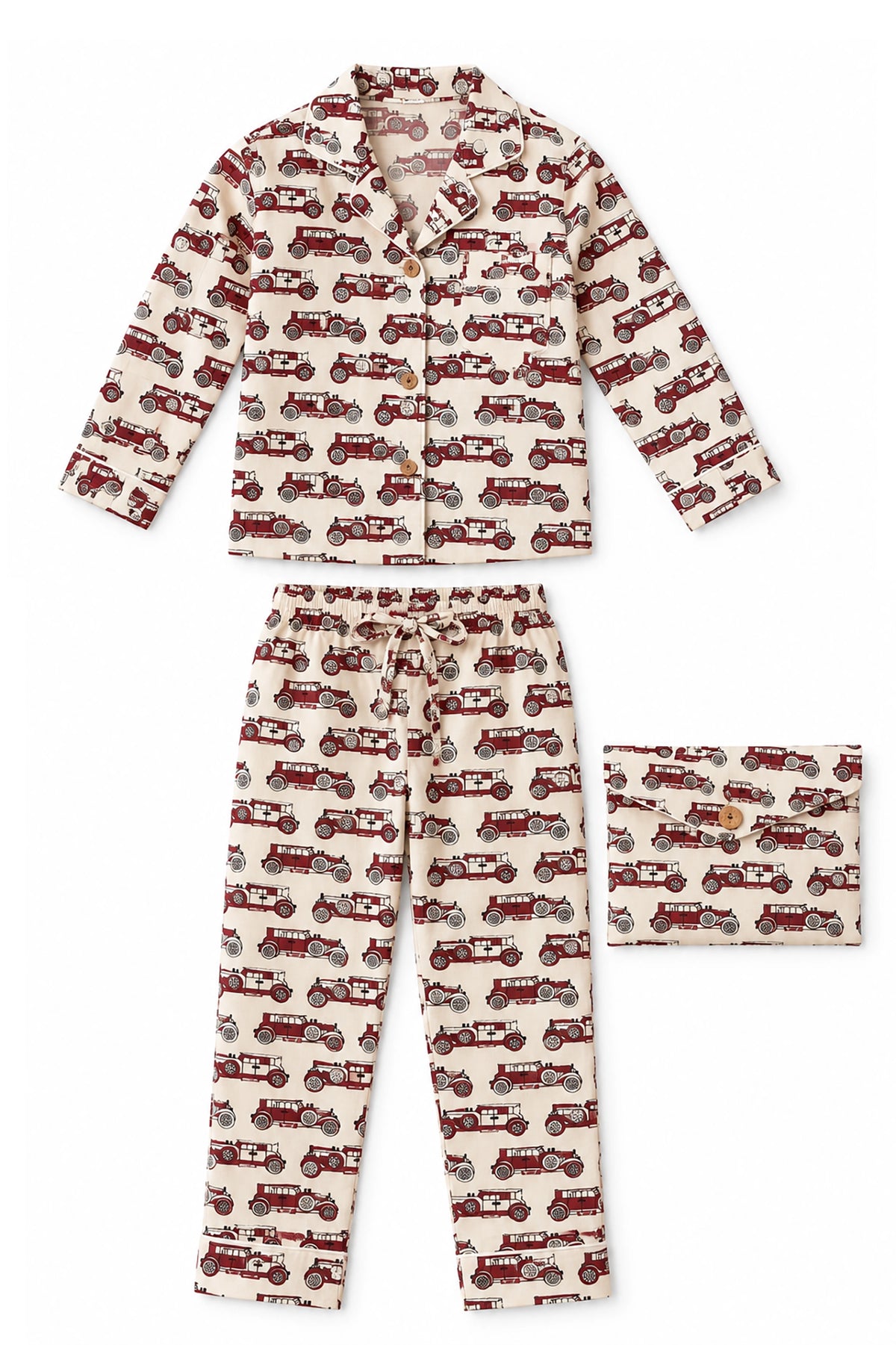A two-piece pajama set featuring a long-sleeve button-up shirt and matching pants, both printed with a repeating pattern of vintage red and gray cars on a cream background. A folded matching square fabric piece is shown to the right of the pants.