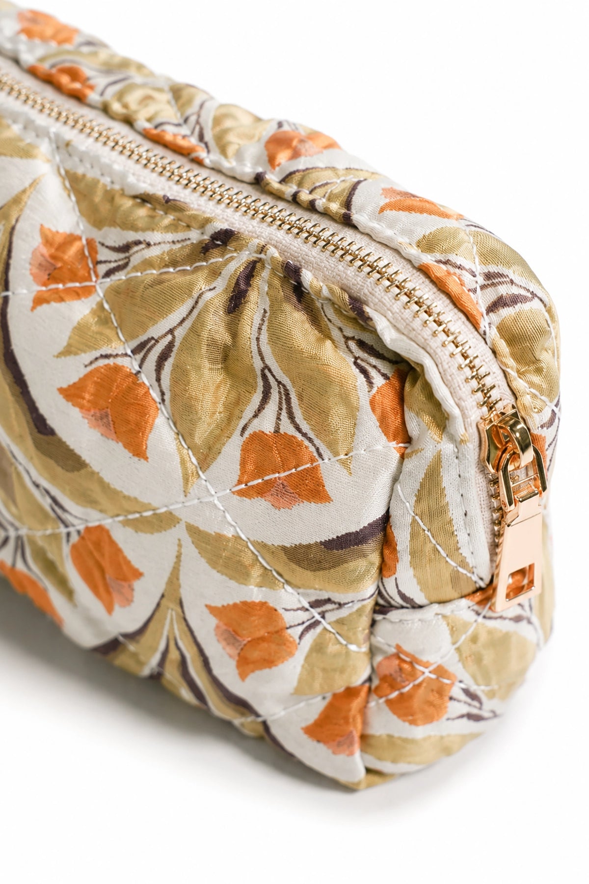 Floral-patterned makeup bag with a gold zipper on a white background
