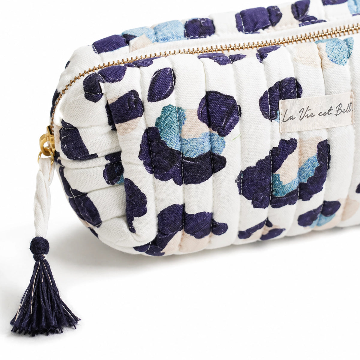 Floral patterned pouch with tassel on a white background