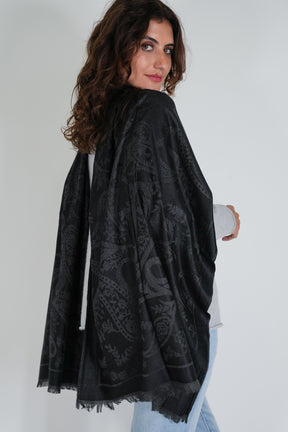 Woman wearing a black patterned scarf on a white background