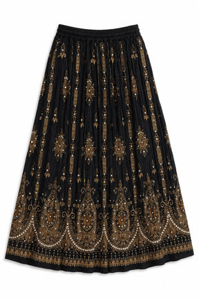 A black pleated midi skirt with intricate gold and beige paisley and floral embroidery, featuring a wide elastic waistband.