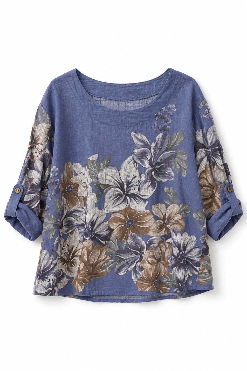 A women's short-sleeve top in dusty blue with a large floral print in beige, brown, and gray, featuring rolled-up sleeves with button details.