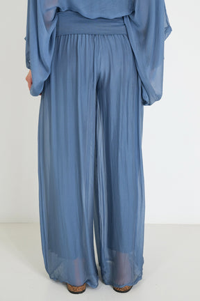 Blue outfit with a top and wide-leg pants on a white background