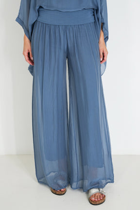 Blue outfit with wide-leg pants on a white background