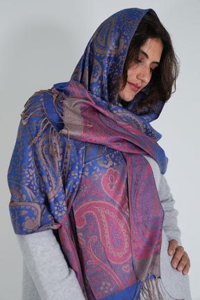 Woman wearing a blue and pink patterned scarf on a white background