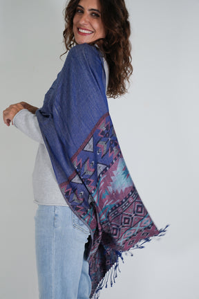 Woman wearing a blue patterned scarf on a white background
