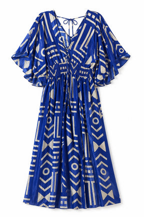 A royal blue midi dress with a cream geometric pattern, featuring wide flutter sleeves, a V-neckline with tie details, and a gathered waist.