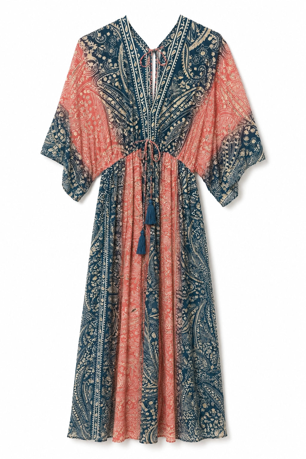 A long, loose kaftan dress with a blue and coral-pink paisley pattern, featuring a split V-neckline, tie waist, and tassel details, shown against a plain white background.