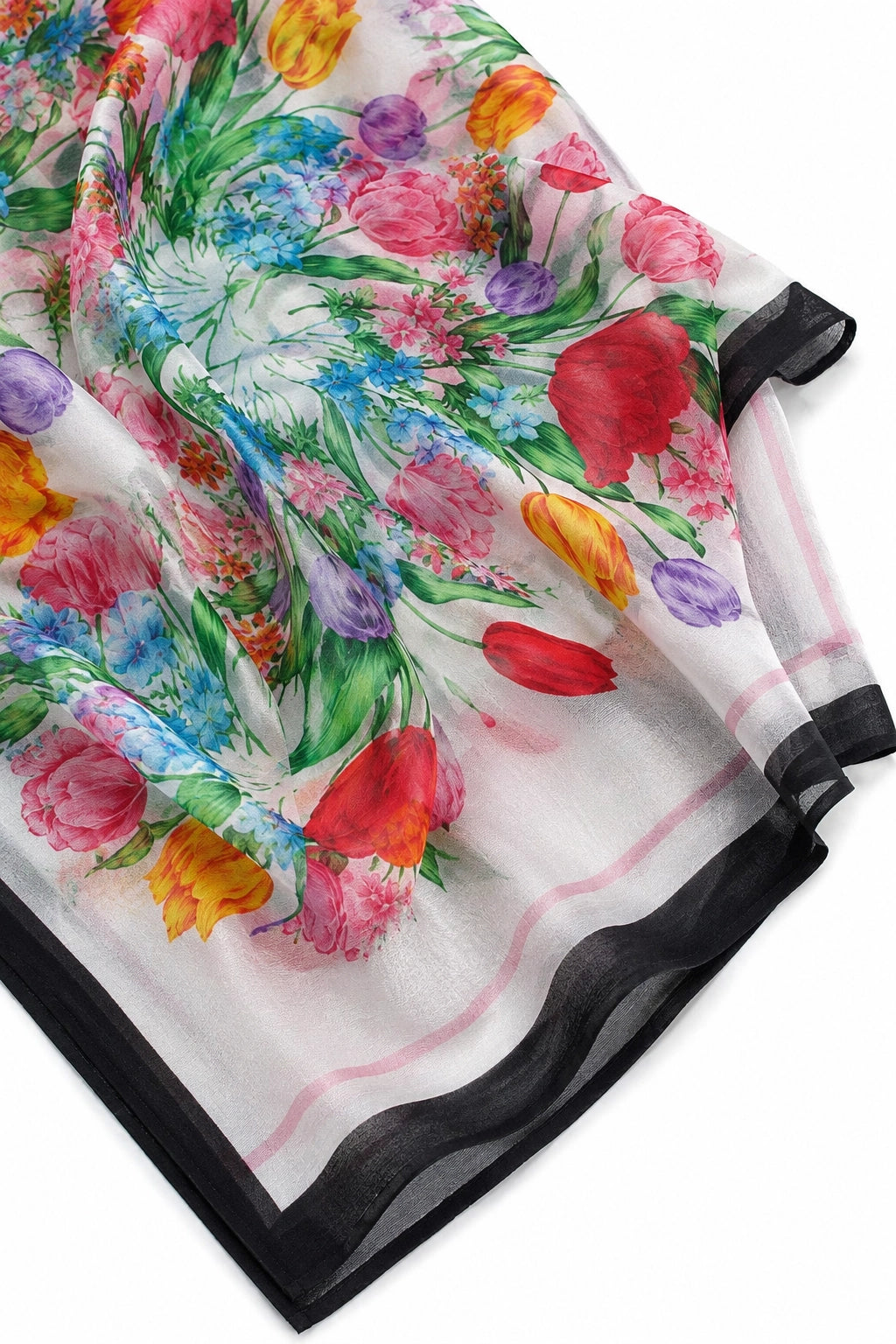A lightweight white scarf with a vibrant multicolor floral print and a black border, shown draped on a white background.