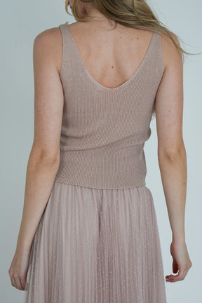 Back view of model wearing beige ribbed V-neck top and blush pink pleated tulle midi skirt, showing texture and fit.