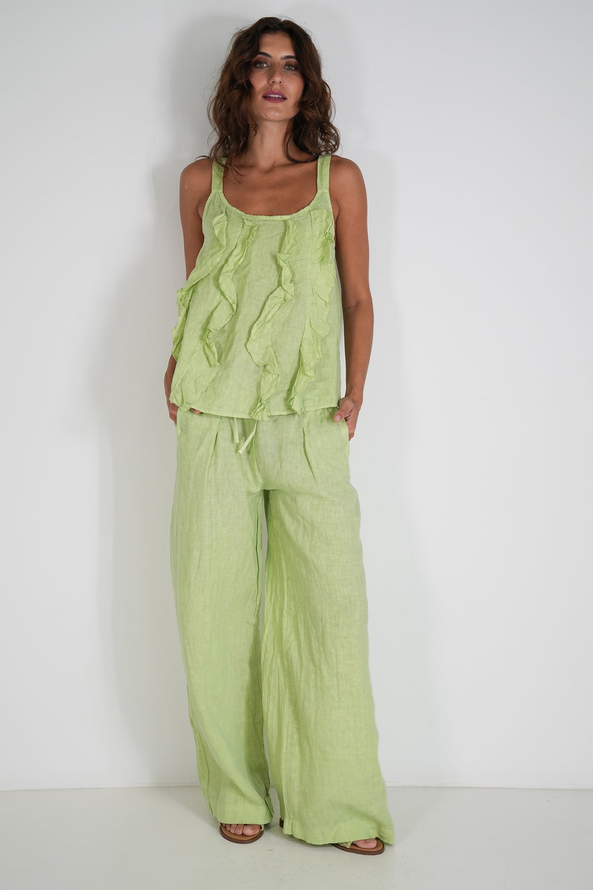 Woman wearing a green outfit against a white background