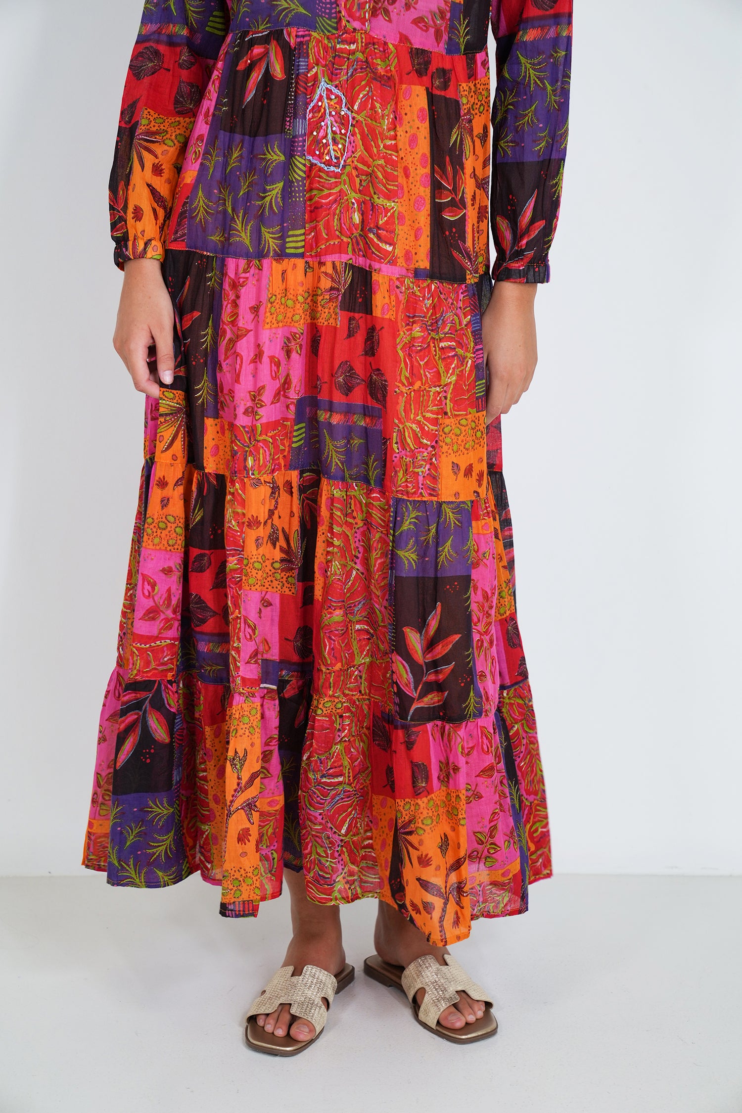Colorful patchwork dress with long sleeves on a white background