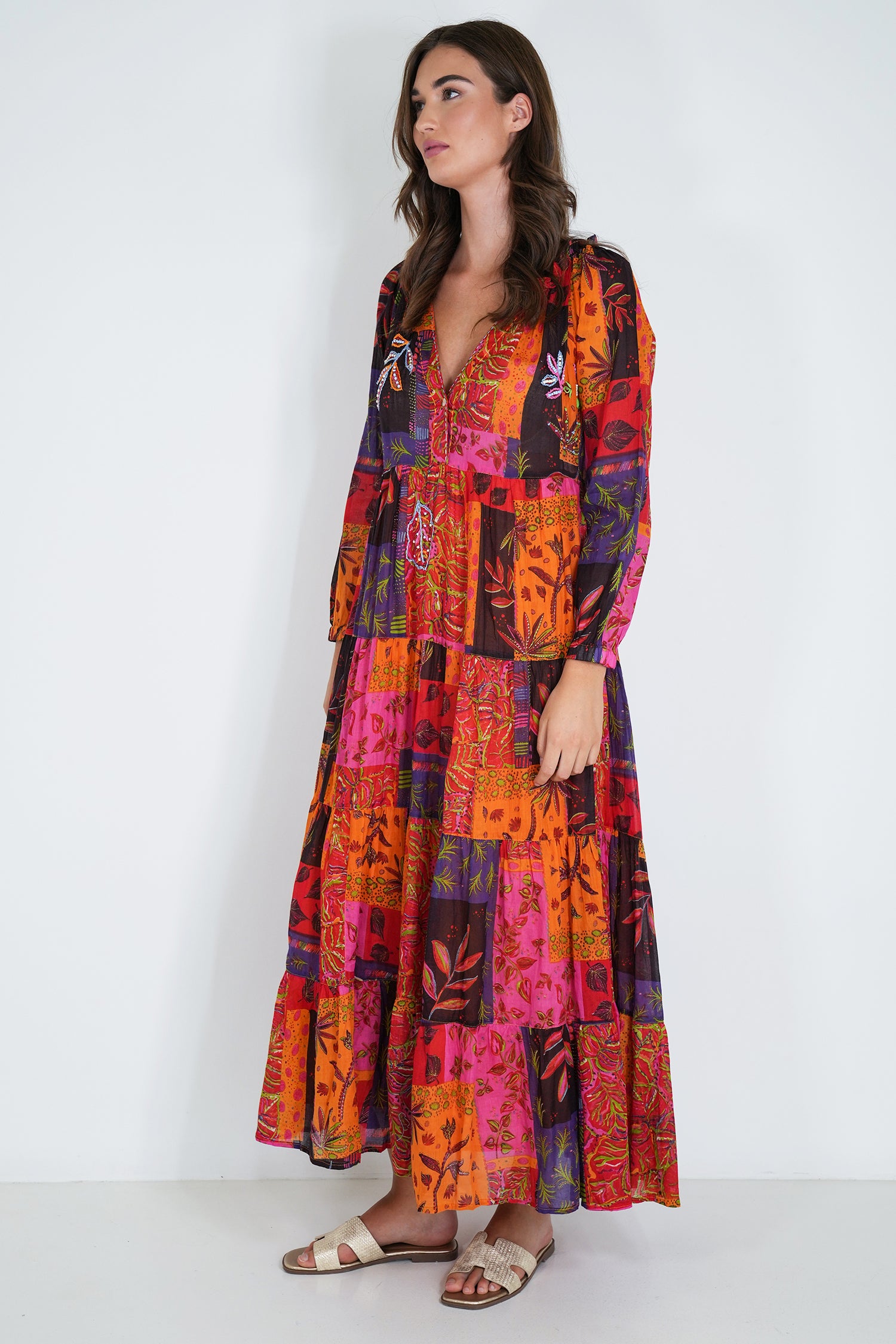 Woman wearing a colorful patchwork dress on a white background