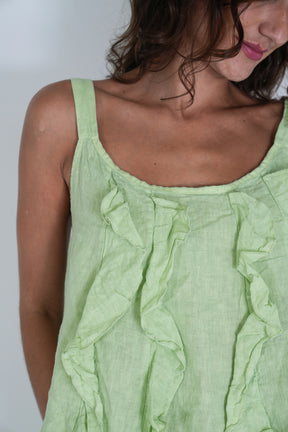 Close-up of a light green sleeveless top worn by a person.