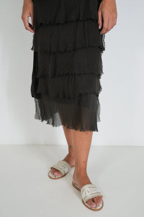 Detail of tiered ruffle skirt and sheer hem on the Chocolate Overlay Tier Silk Dress