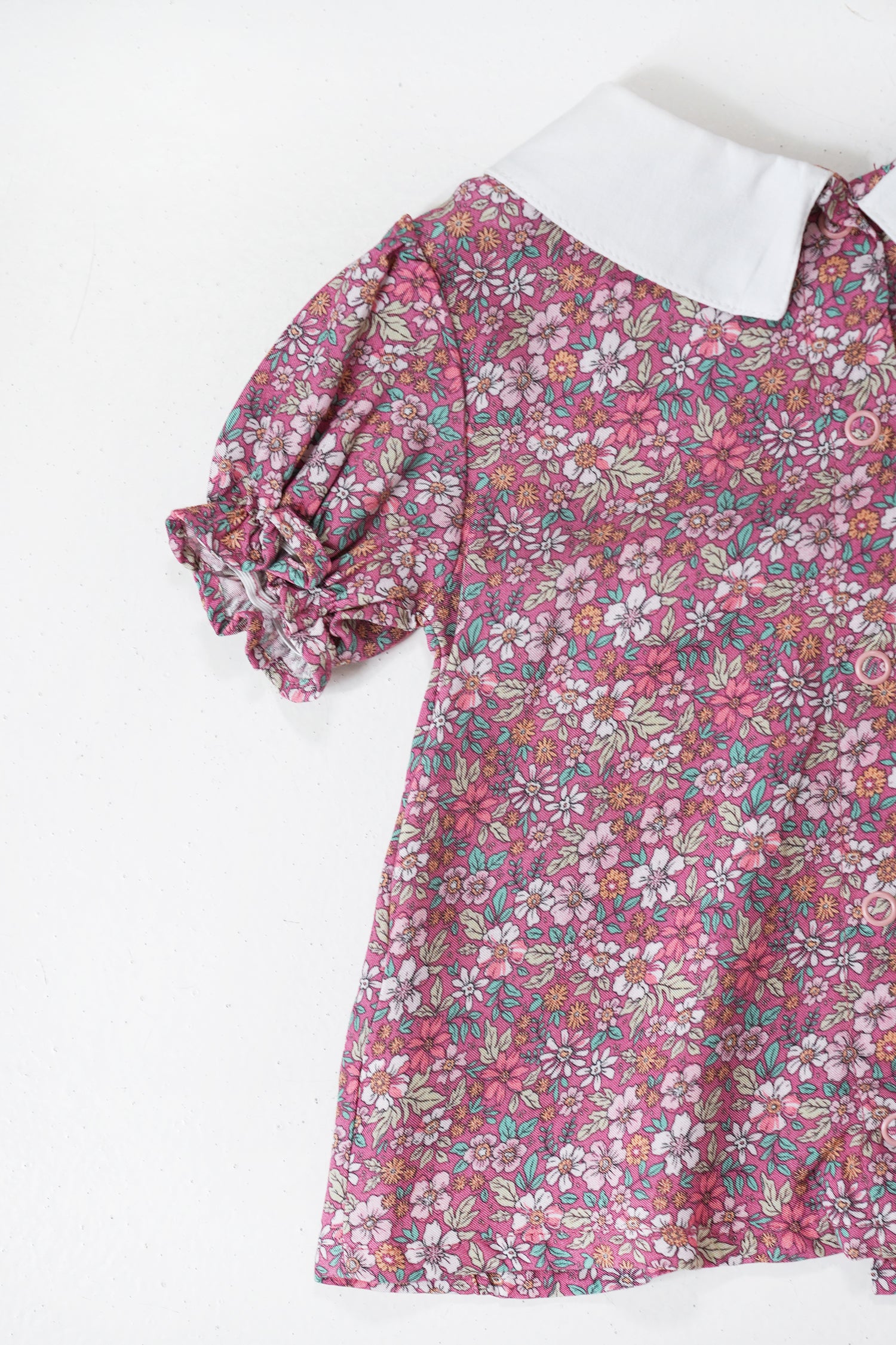 Floral dress with a white collar on a white background
