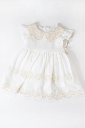 White dress with lace details on a white background