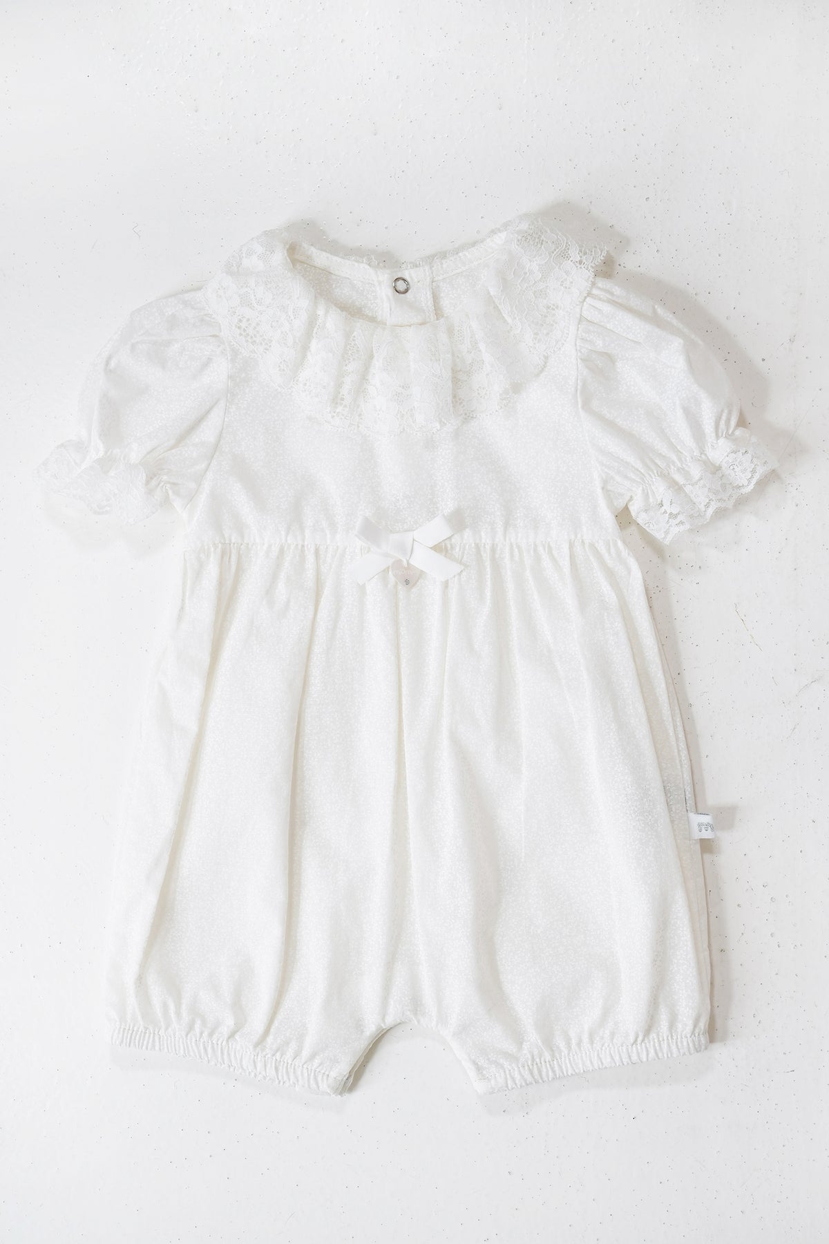 White baby romper on a white background