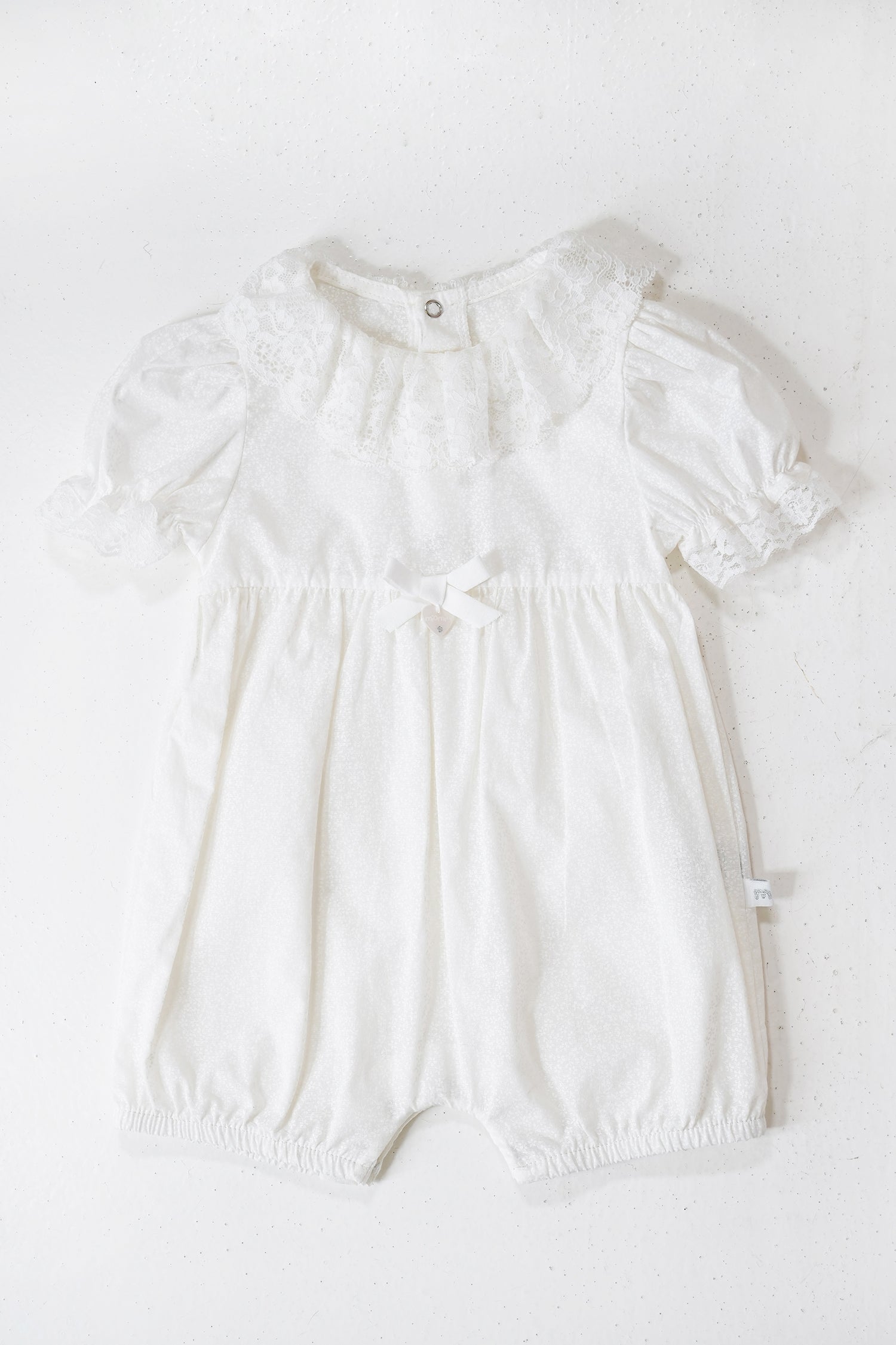 White baby romper on a white background