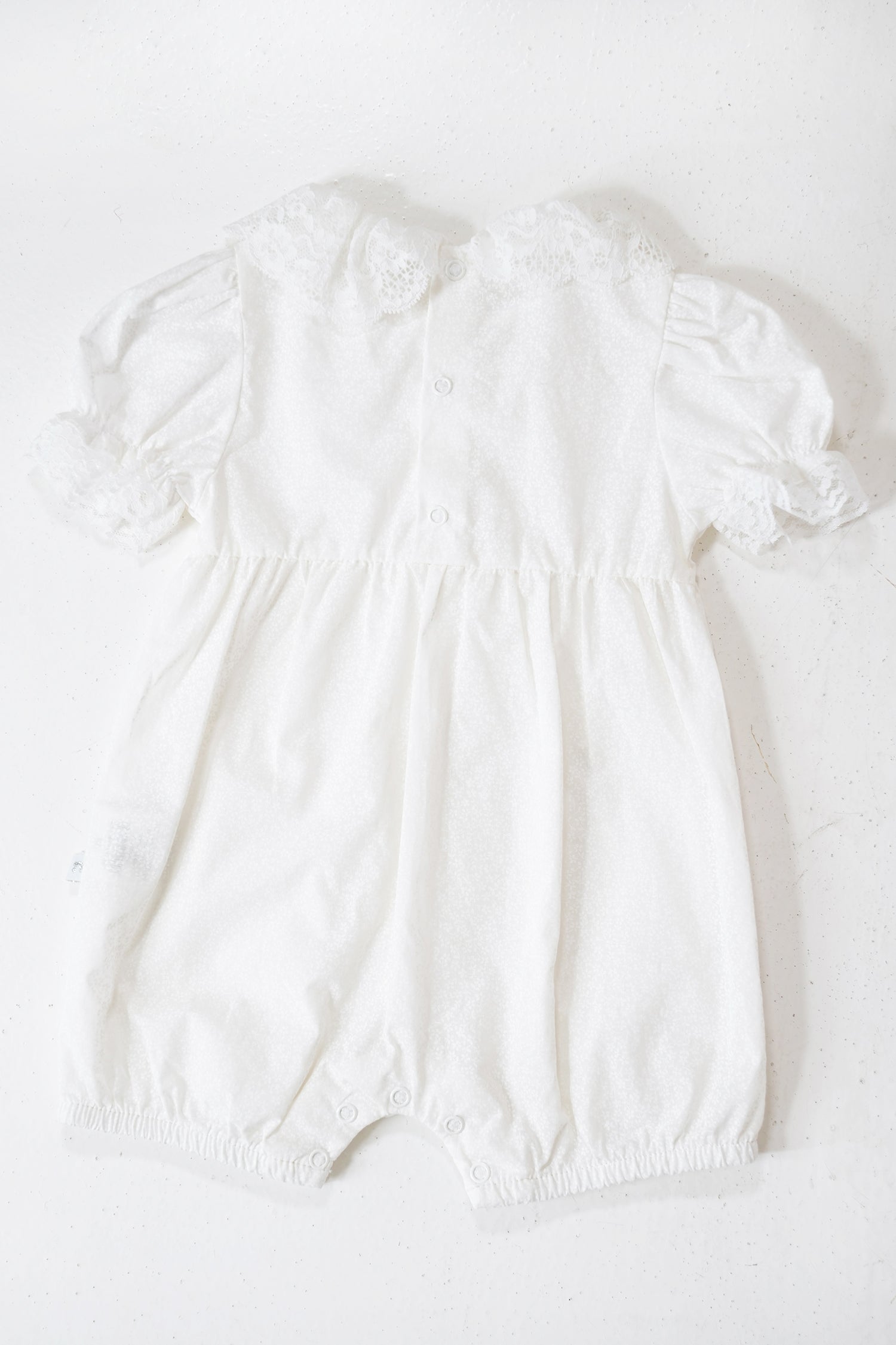 White baby romper on a white background