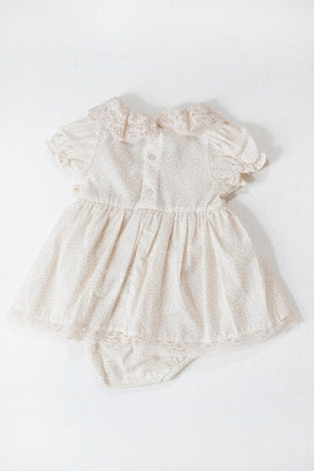 White lace baby romper on a white background