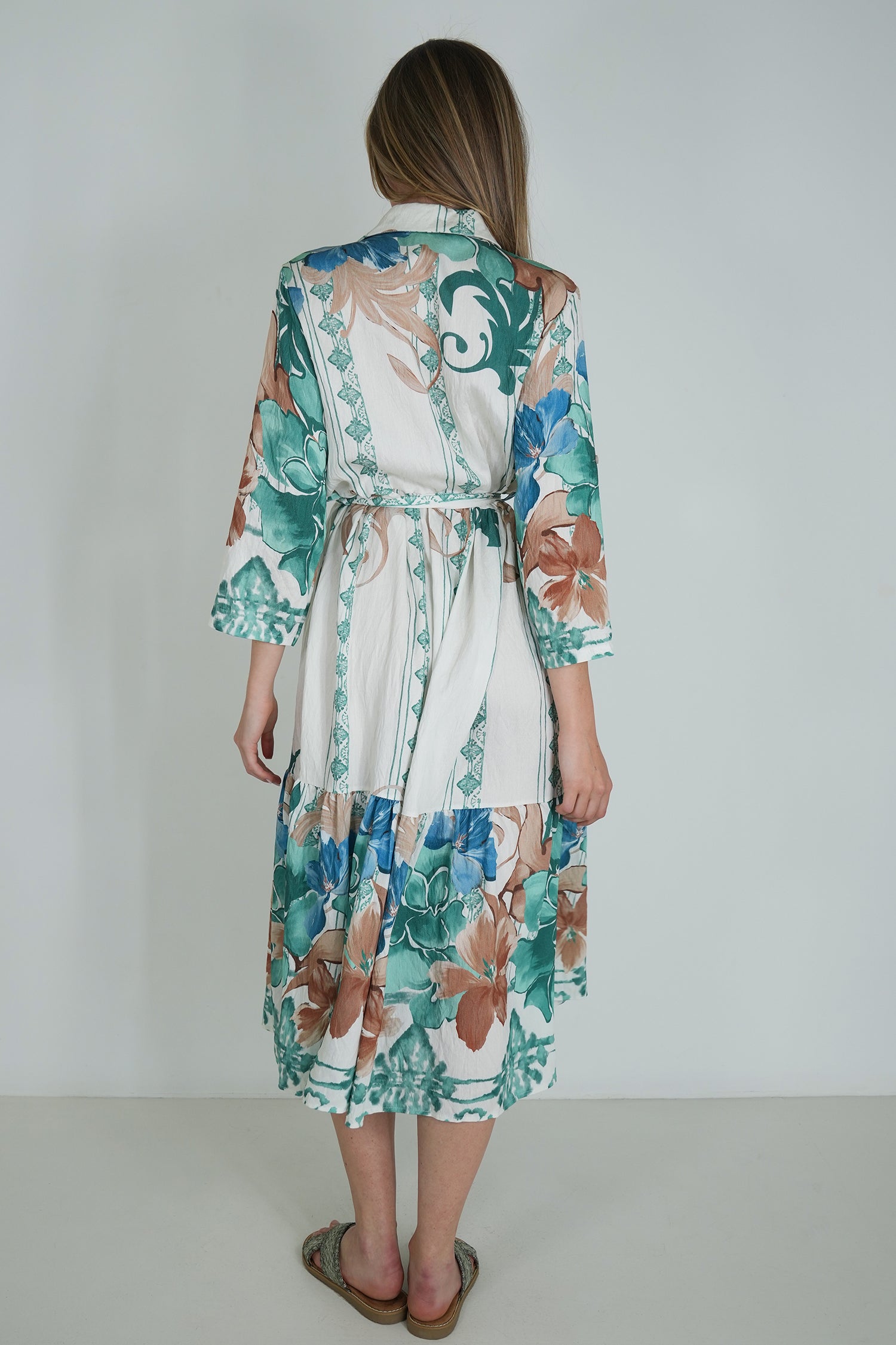 Woman wearing a floral dress with a white background