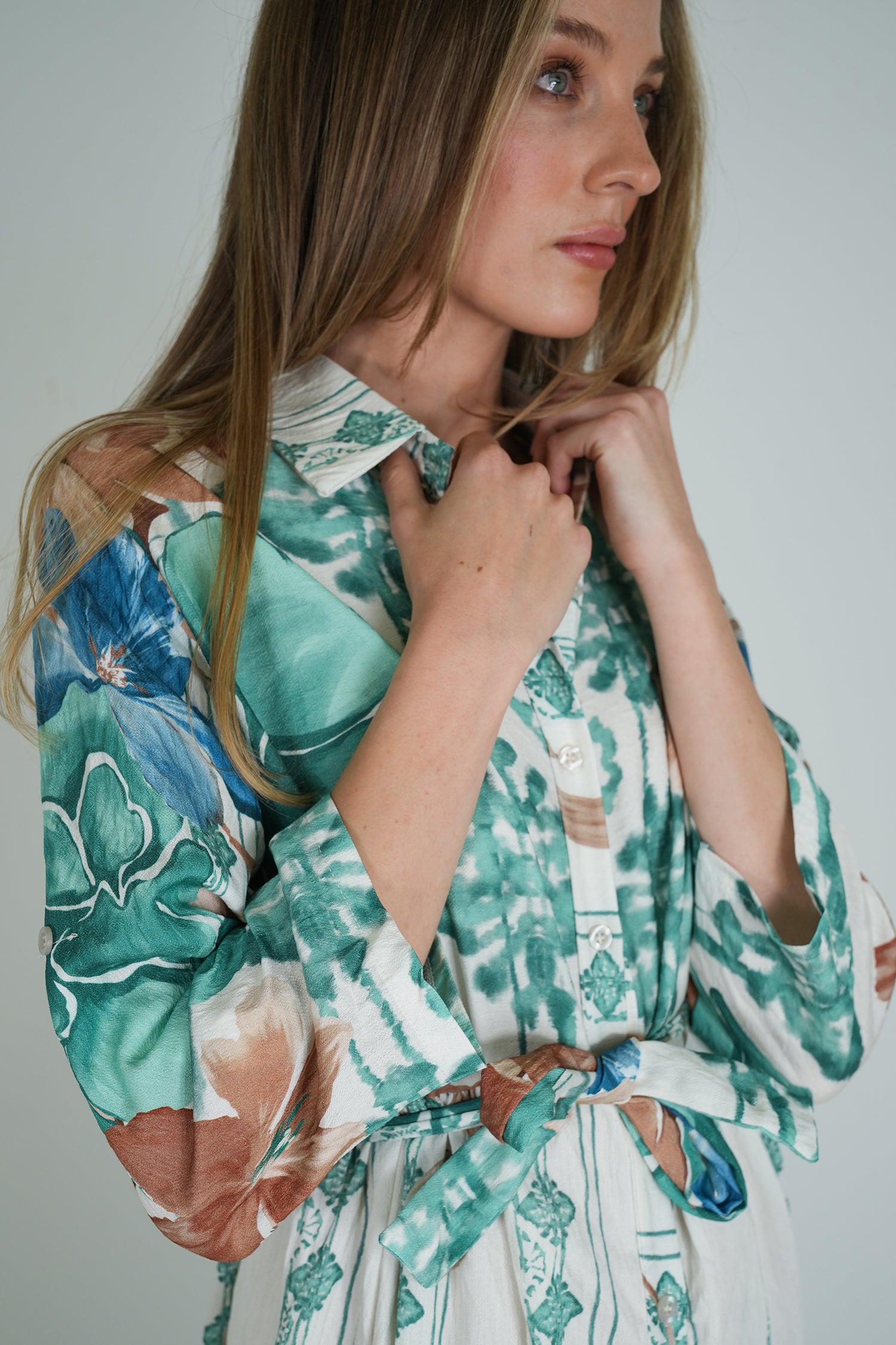 Woman wearing a floral dress with a neutral background