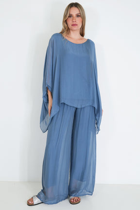 Woman wearing a blue outfit with a plain white background