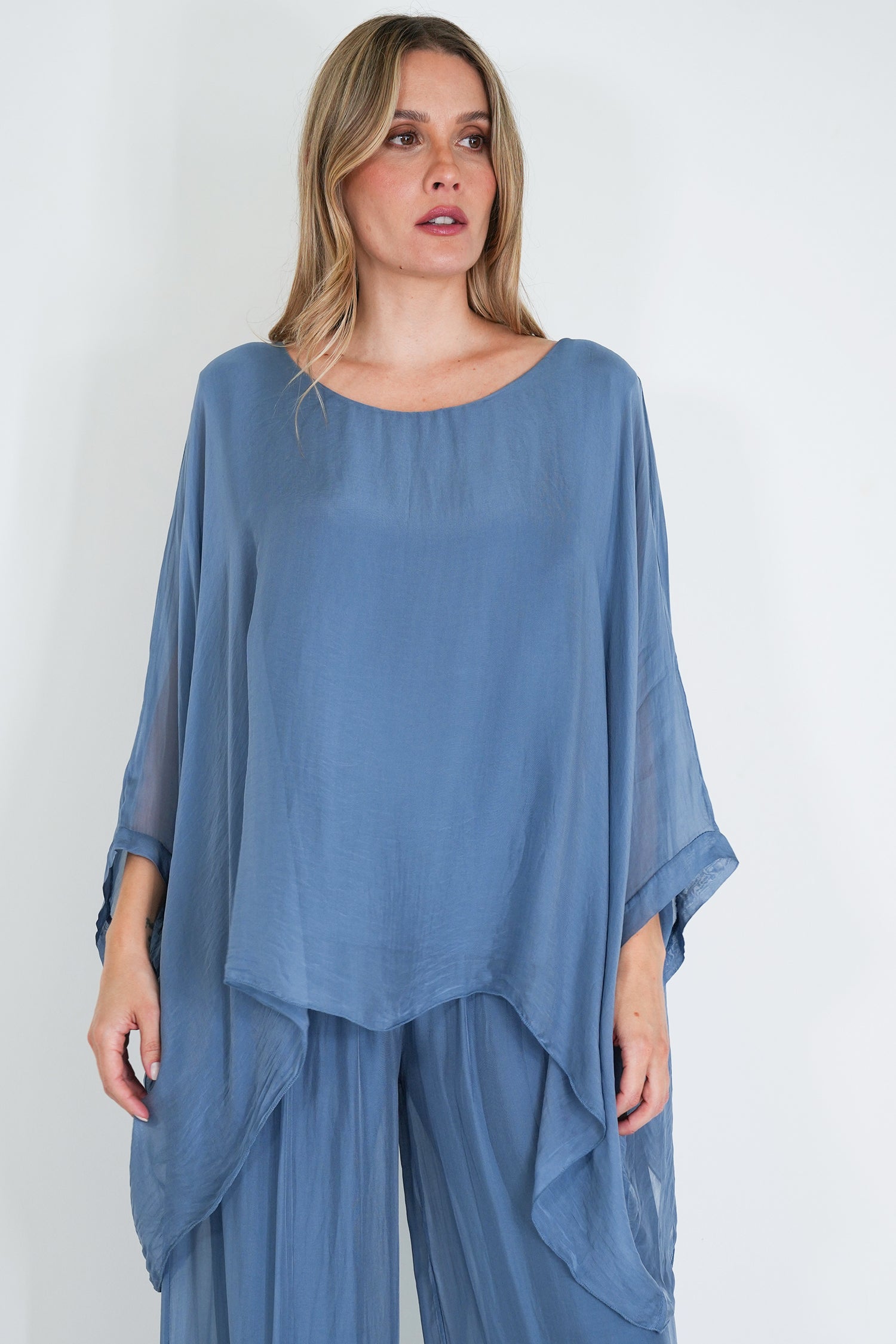 Woman wearing a blue outfit with a plain background