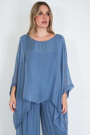 Woman wearing a blue outfit with a plain background