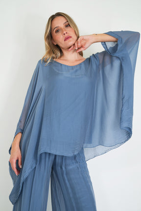 Woman wearing a blue outfit with a white background