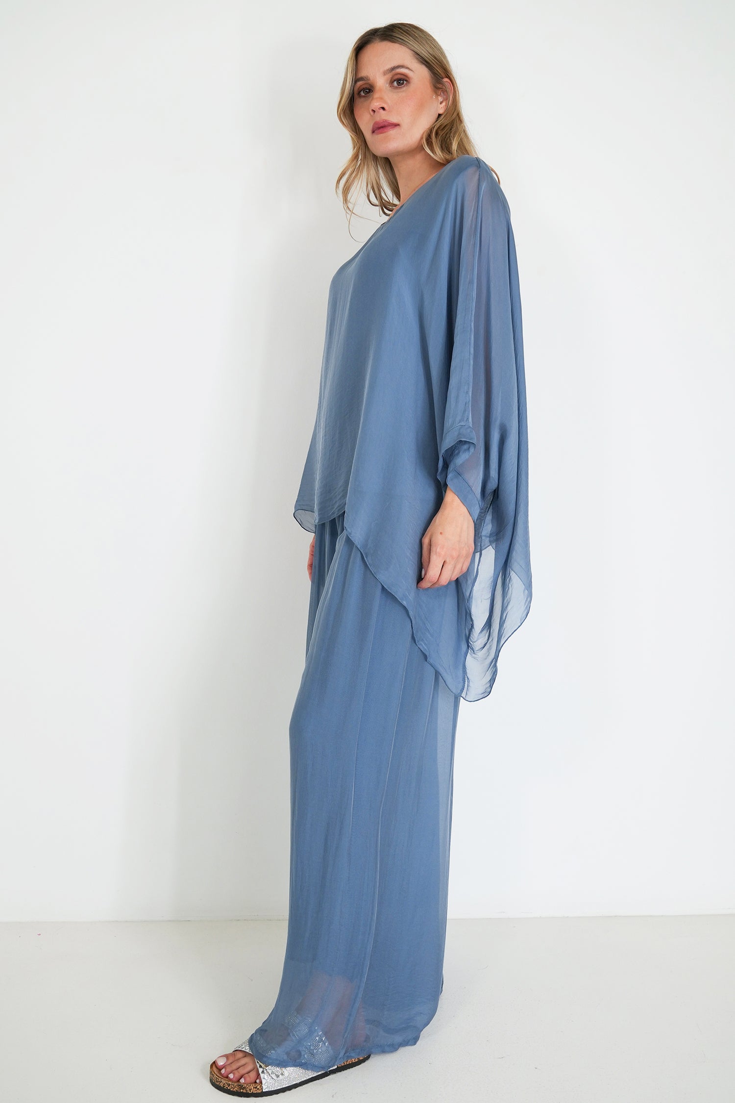 Woman wearing a blue dress against a white background