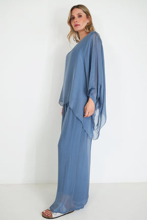 Woman wearing a blue dress against a white background