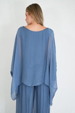 Woman wearing a blue outfit with a plain background