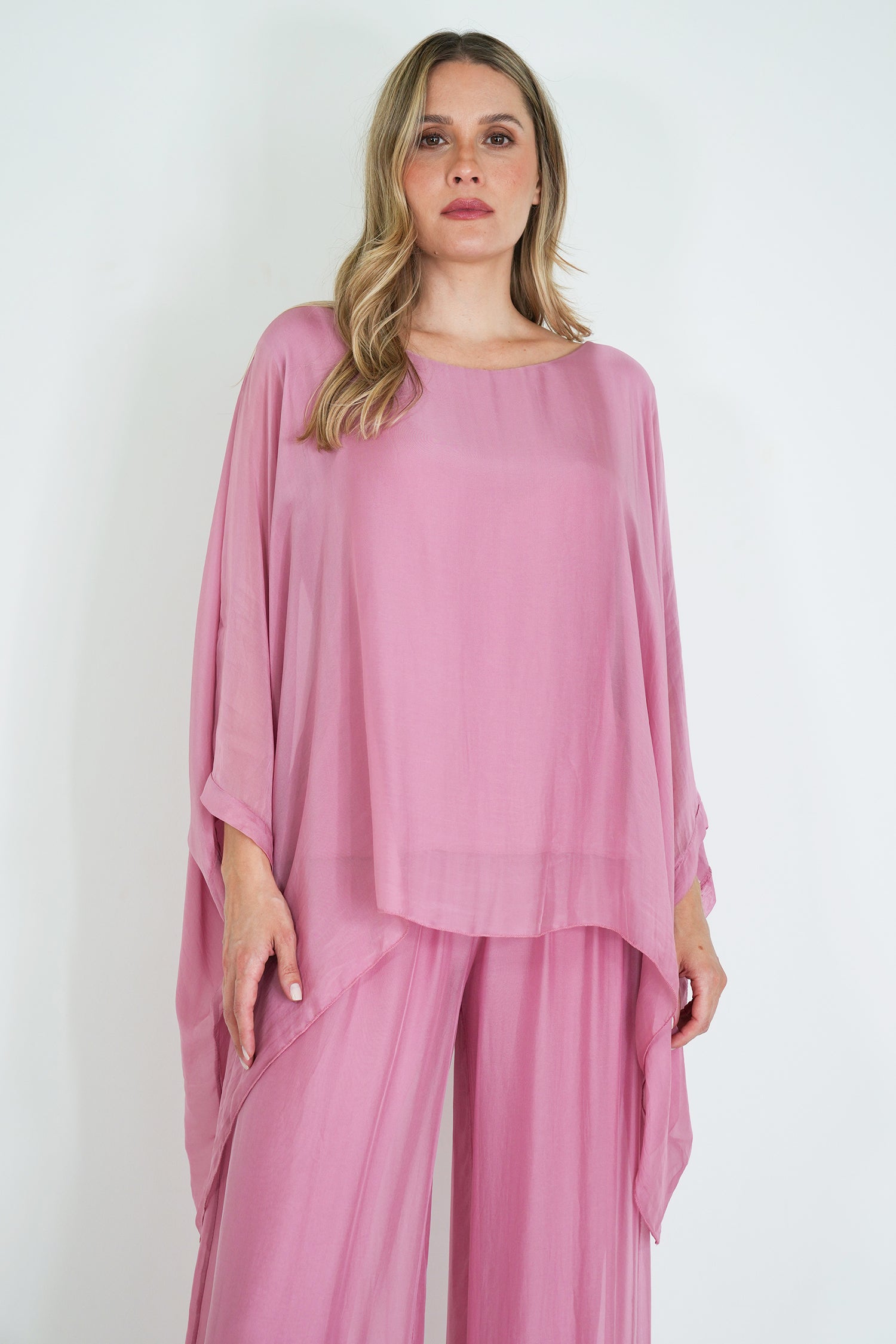 Woman wearing a pink outfit on a white background