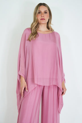 Woman wearing a pink outfit on a white background