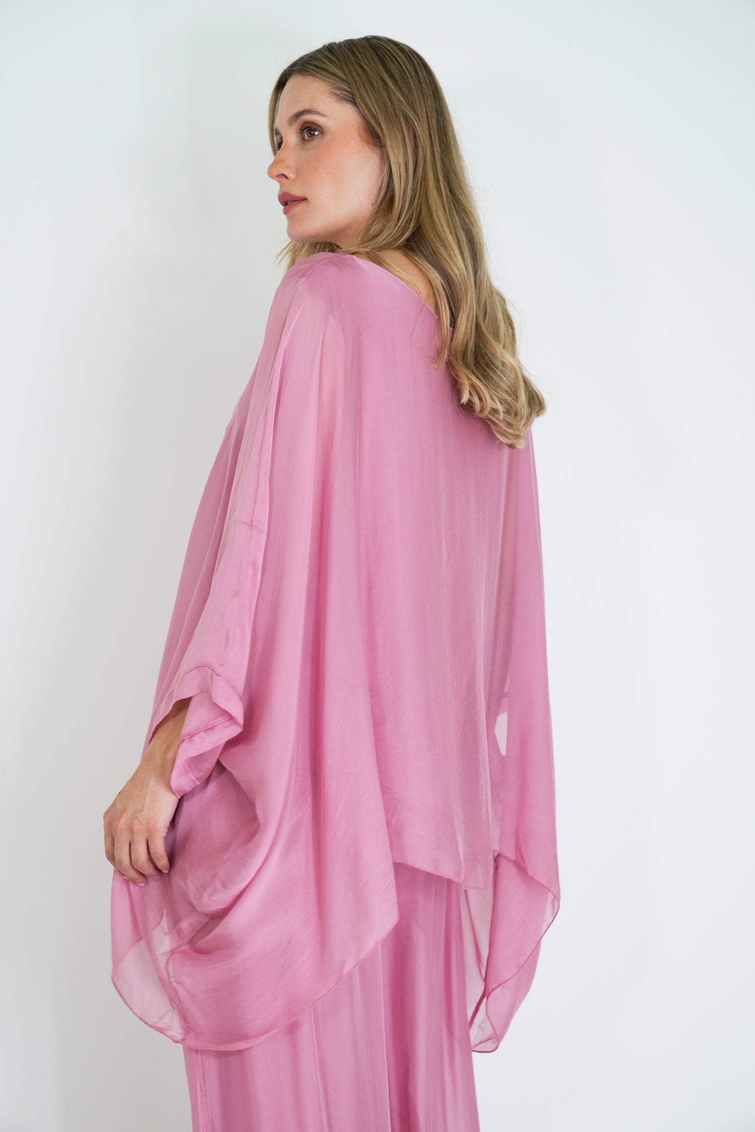 Woman wearing a pink dress against a white background