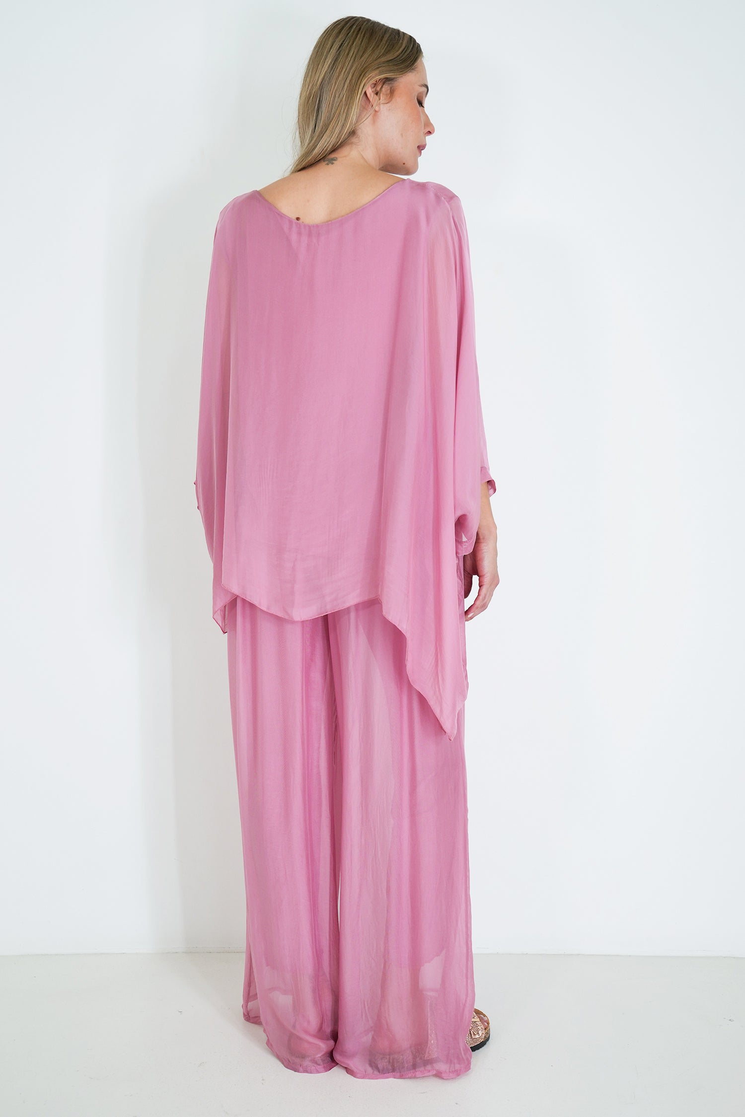 Woman wearing a pink outfit with a white background