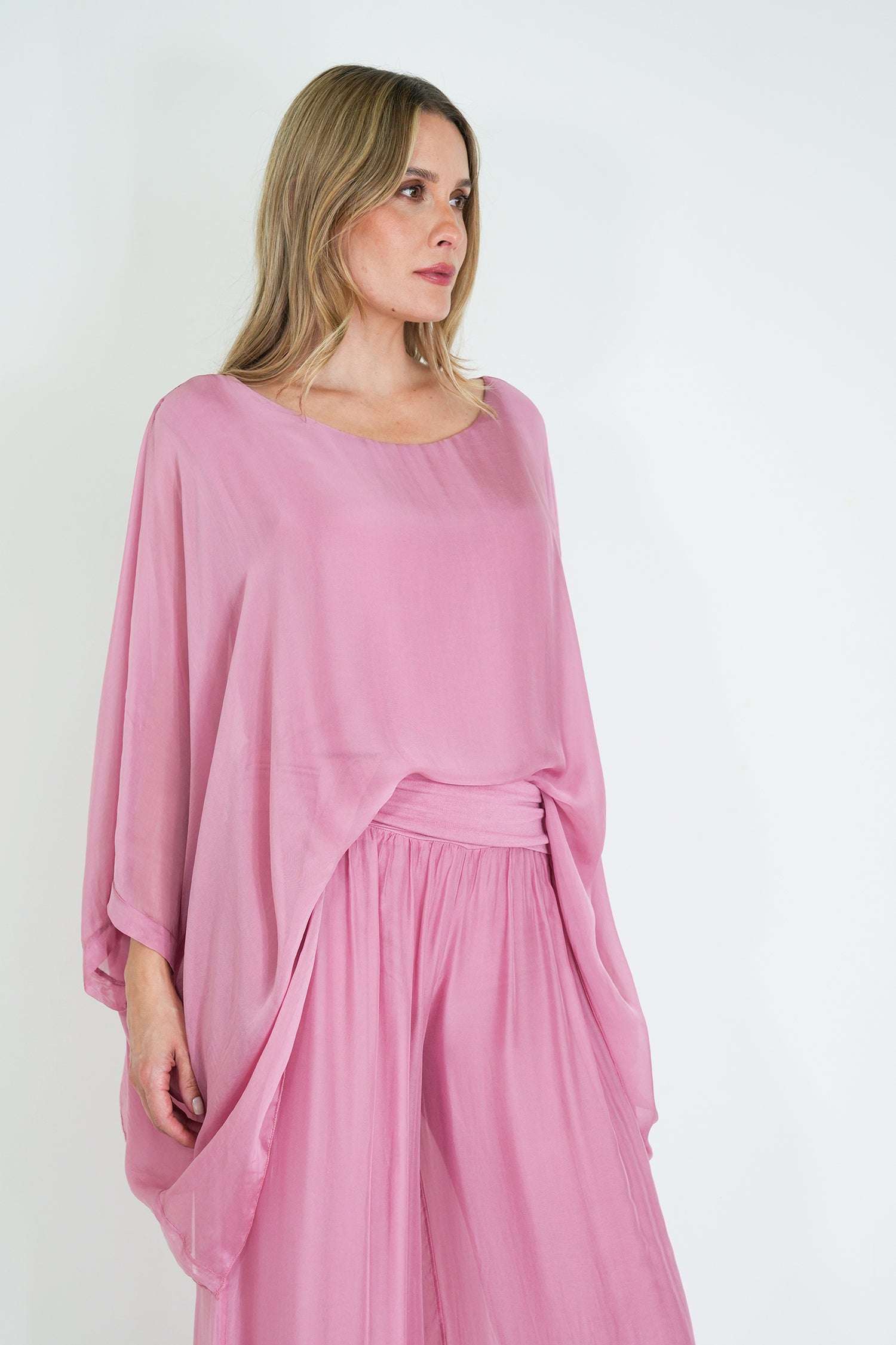 Woman wearing a pink dress against a white background