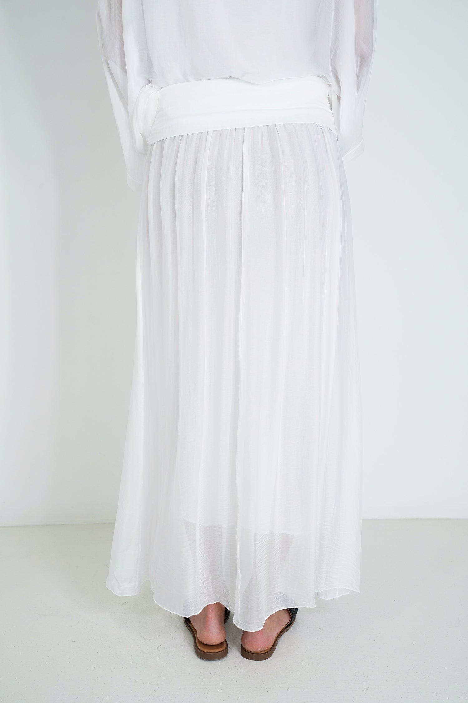 White dress with a belt on a white background