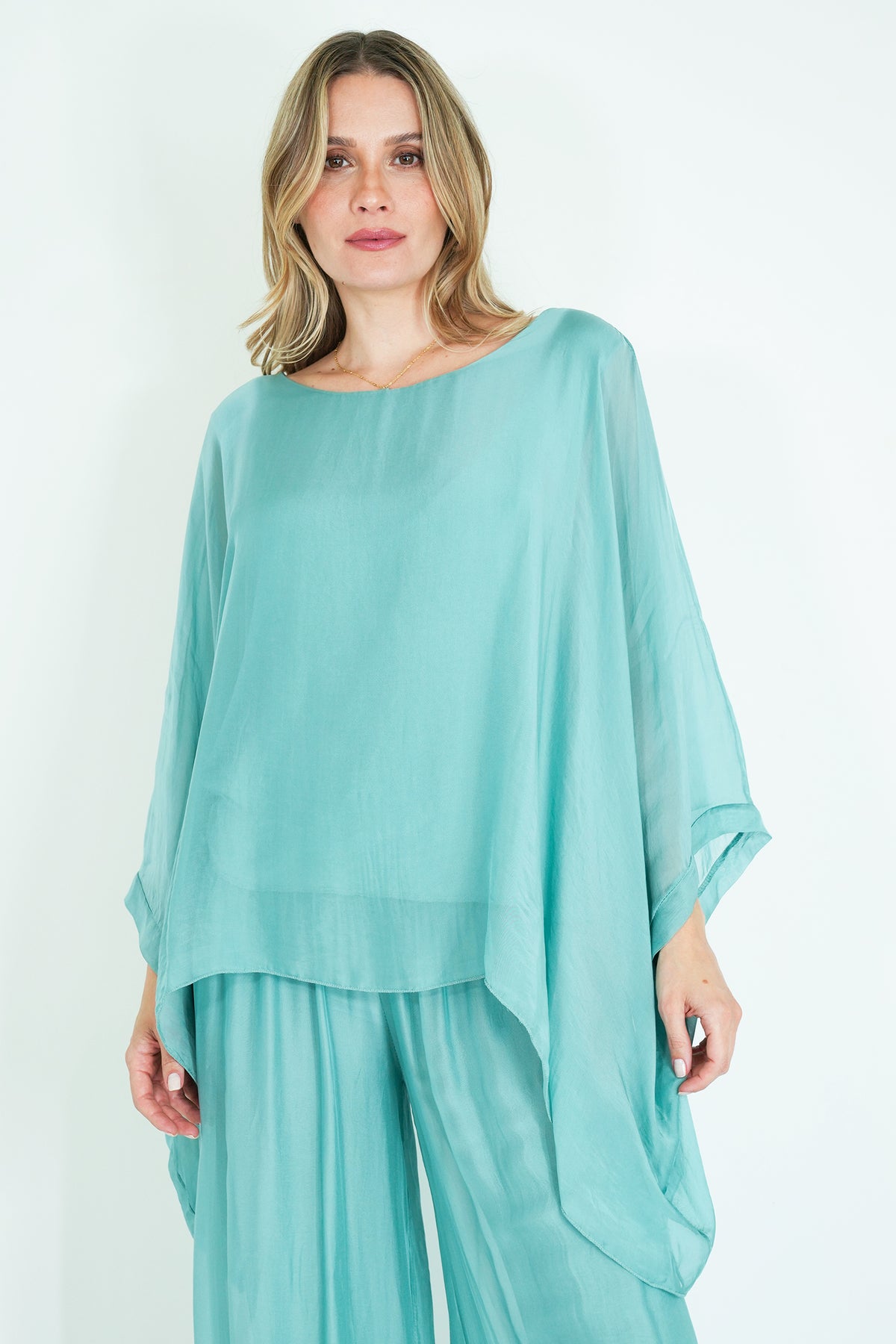 Woman wearing a light blue outfit on a white background